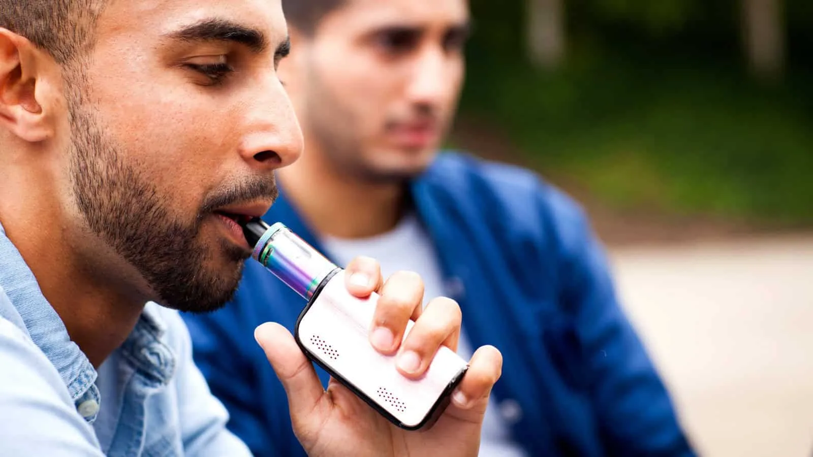 Man vaping a box mod kit — adult vaper using a regulated device
